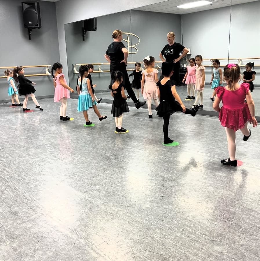 Mini program students in tap formation with two faculty members at Evolve Dance Center
